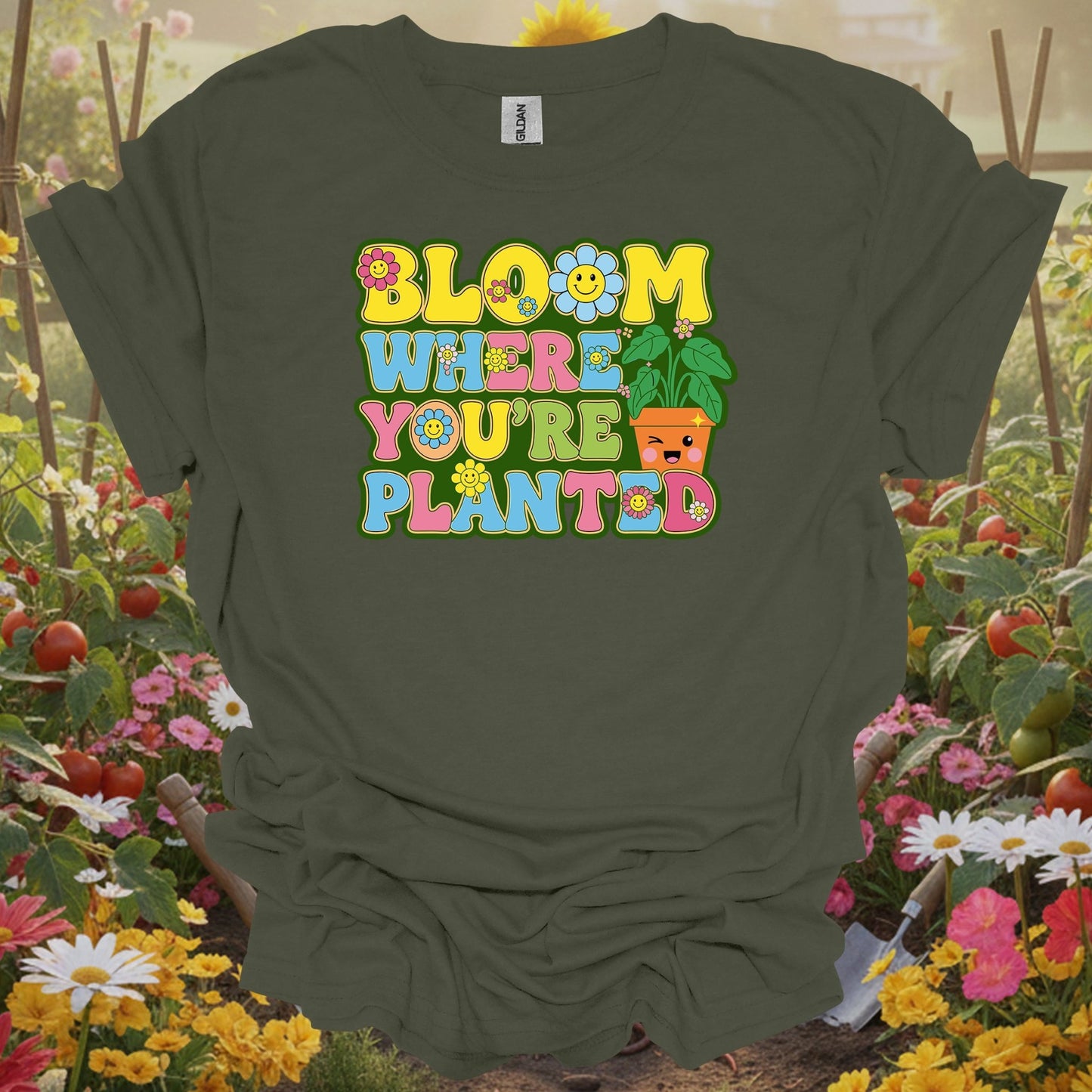 Military Green top showing retro smiley face with bloom where planted floral design for resilient bloomers