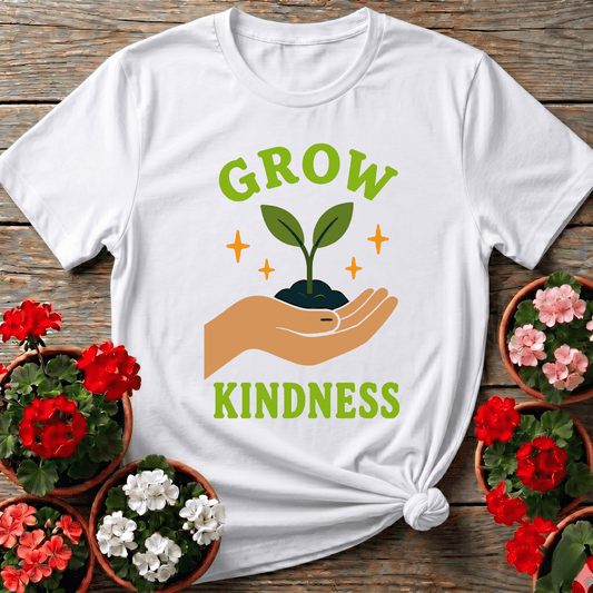White warm modern botanical shirt with "Grow Kindness" open hand seedling graphic for kind-hearted gardeners