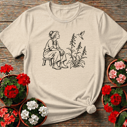 Natural vintage sketch style gardening top with cottagecore woman sitting quietly as hummingbird hovers near foxglove