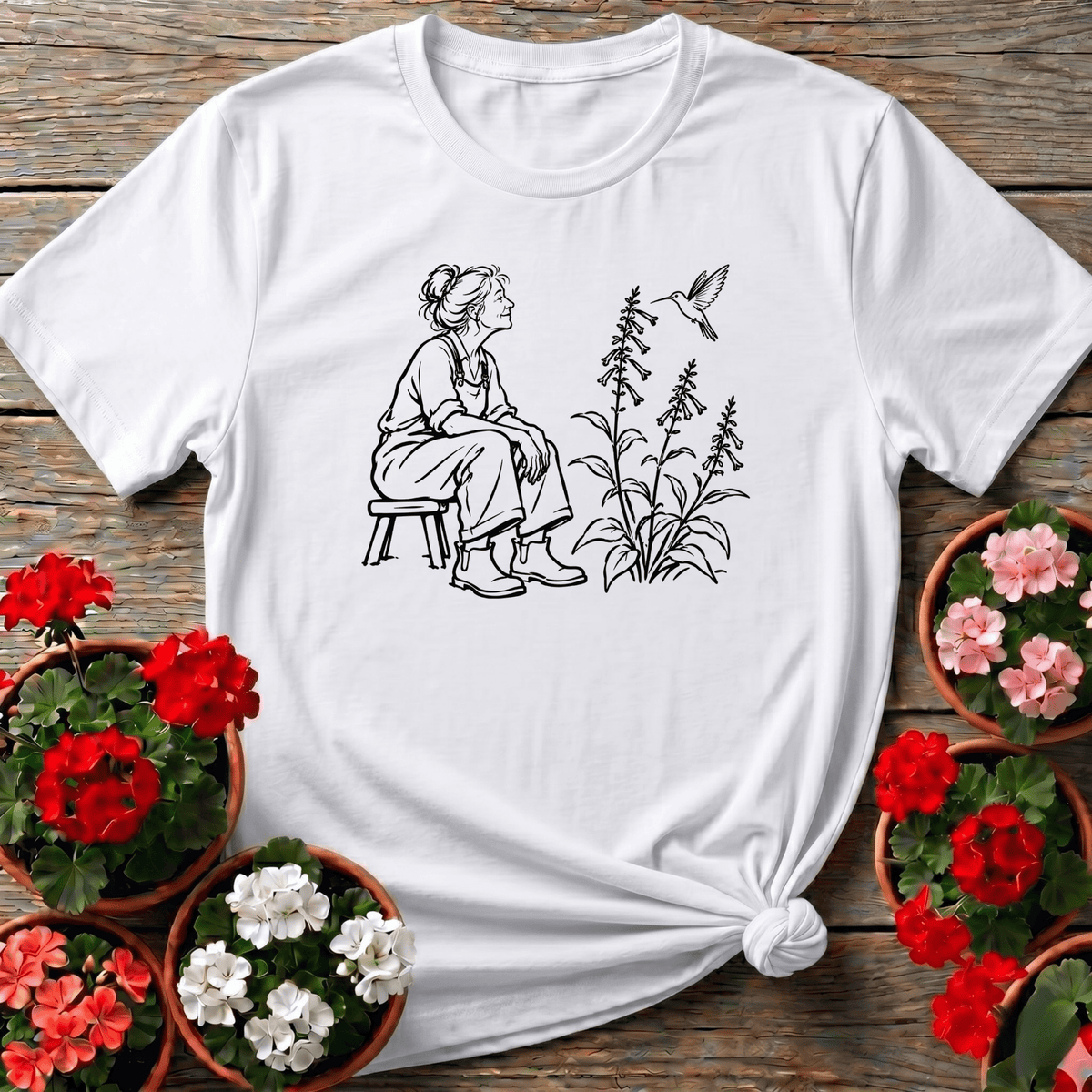 White cottagecore sketch style gardening shirt with seated woman gardener and hummingbird for nature lovers
