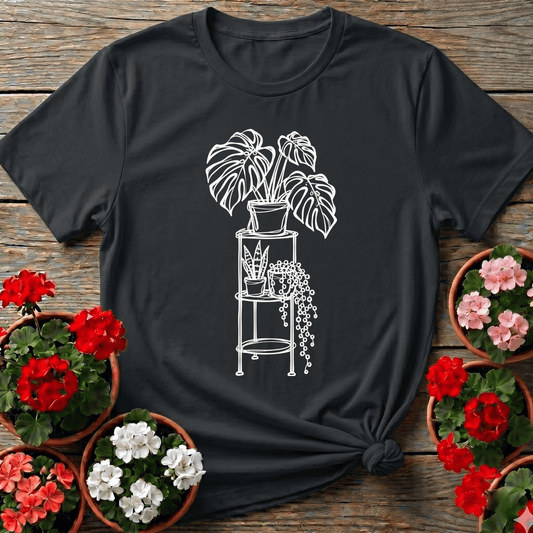 Black minimal line art houseplant tee with monstera snake plant and string of pearls on a tiered plant stand for indoor plant lovers