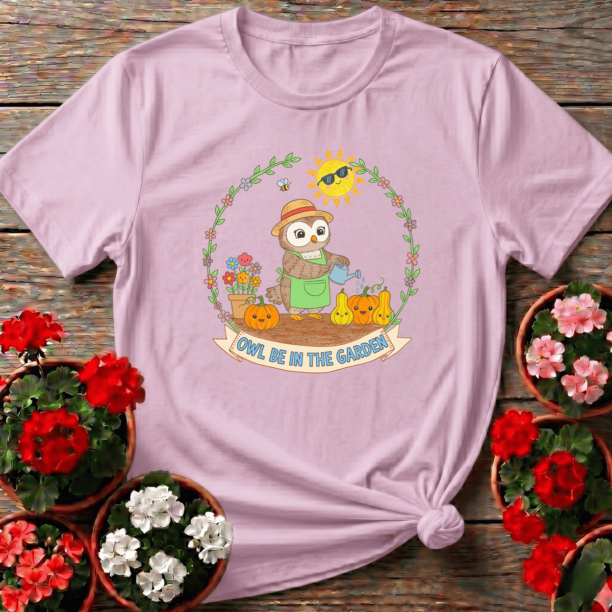 Light Pink gentle whimsical owl gardening apparel with floral vine wreath and cheerful sun for gift giving