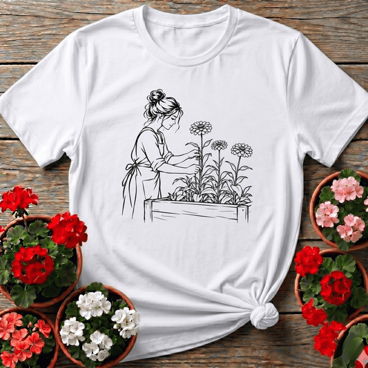 White sketch style botanical gardening shirt with woman in apron tending a zinnia raised bed for gardeners
